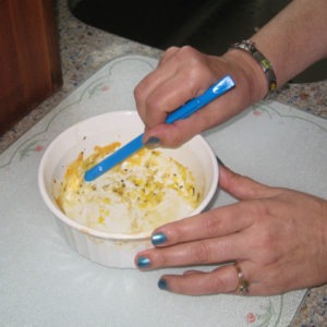 Scraping round Corningware dish